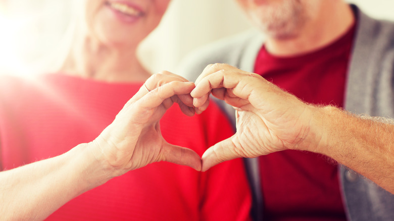 two people making a heart with their hands