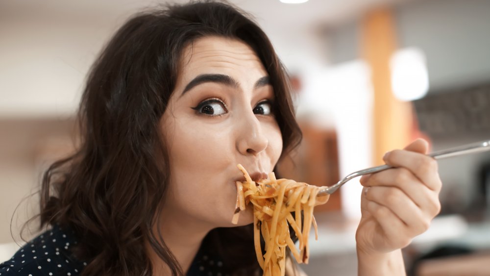 Woman eating pasta